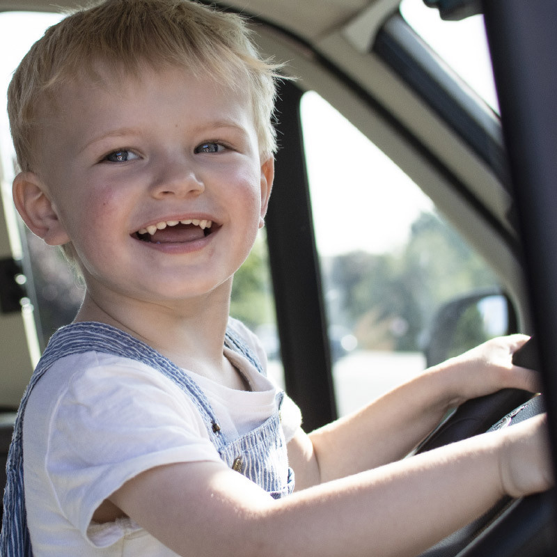 Child at motorhome wheel in cab