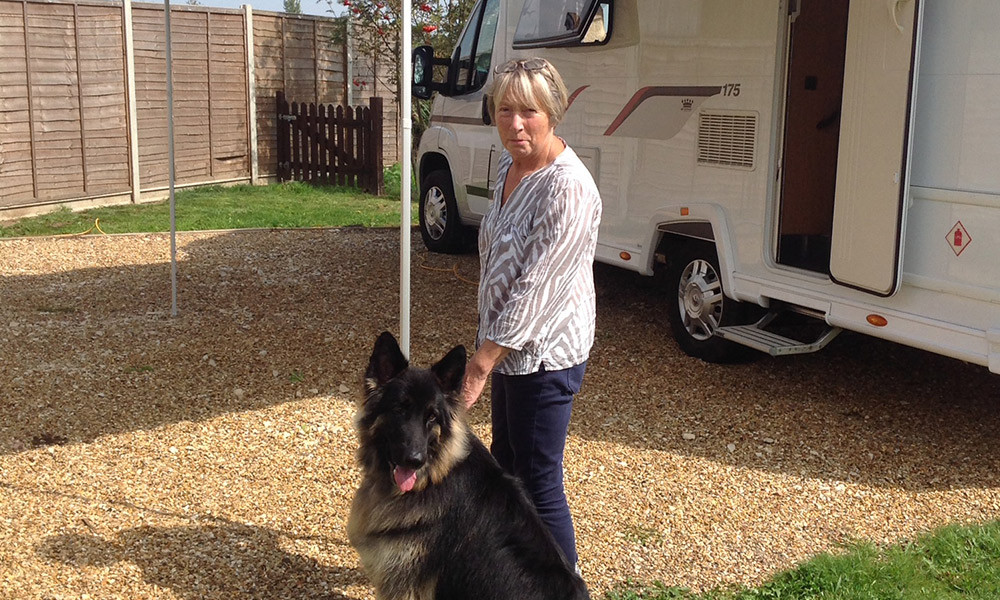 Val outside the motorhome with her dog